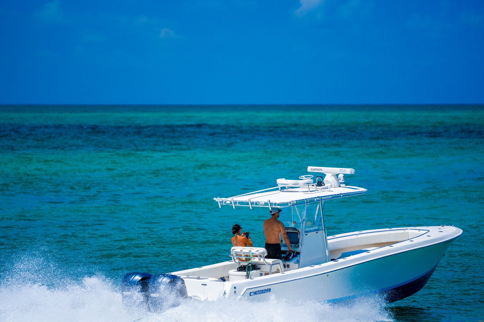 Couple cruising on a Contender fishing boat in Miami - two people enjoying the ocean experience
